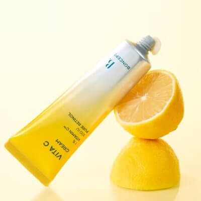 Boncept Vita C Cream (50ml) - Vitamin C & Retinol Radiance Moisturizer with lemon slices on a yellow background.
